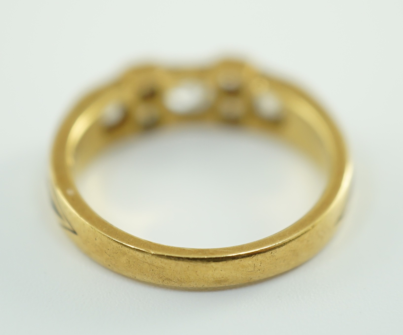 A late 19th century gold and seven stone old mine cut diamond and black enamelled cluster half hoop ring